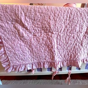 Pottery Barn ruffle quilt for crib in pink.
